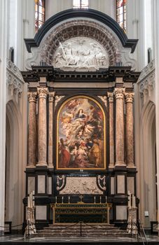 Antwerp, Belgium - September 24, 2018: The Assumption of the Virgin Mary painting by Rubens above high altar in Onze-Lieve-Vrouwe Cathedral of Our Lady, framed by pillars and crowned by fresco.