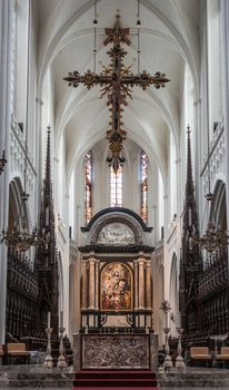 Antwerp, Belgium - September 24, 2018: The Assumption of the Virgin Mary painting by Rubens above main altar in Onze-Lieve-Vrouw Cathedral of Our Lady. Pillars, arches, cross, stables,