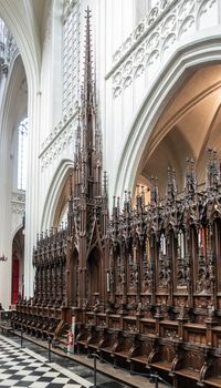 Antwerp, Belgium - September 24, 2018: The row dark wooden sculpted Stables in Onze-Lieve-Vrouwe Cathedral of Our Lady. Members of congragation, leaders and dignitaries seats.
