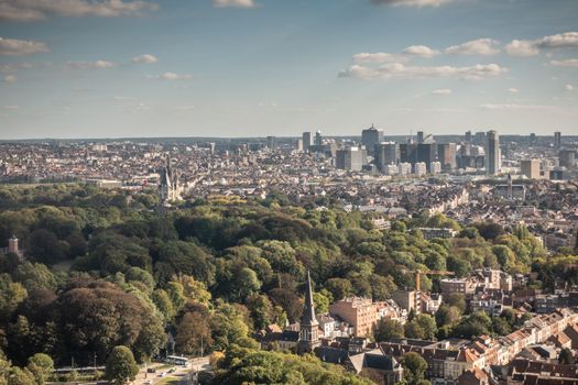 Brussels, Belgium - September 25, 2018: Highrises of North quarter and Laken Park up front seen from the Atomium highest sphere in bluish twilight sky with white clouds.