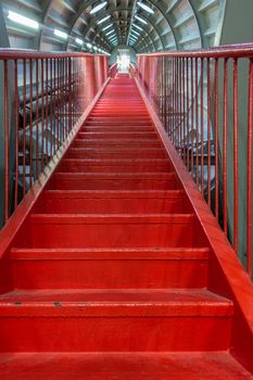 Brussels, Belgium - September 25, 2018: Red endless-like stairway to nowhere or heaven through one tube of Atomium Momument.