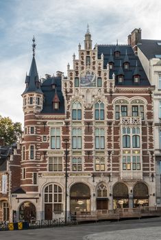 Brussels, Belgium - September 26, 2018: Pharmacie Anglaise in historic mansion with tower,  product names in gold, red-white facade, bluish roof and sun dial on Koudenberg in central Brussels.