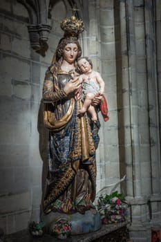 Brussels, Belgium - September 26, 2018: Madonna statue at Cathedral of Saint Michael and Saint Gudula. Gray stone background.