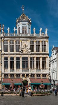 Brussels, Belgium - September 26, 2018: The white-gray facade with golden statues and patio in front of Le Roy d’Espagne, the King of Spain, bar and restaurant on Grand Place, Grote Markt.
