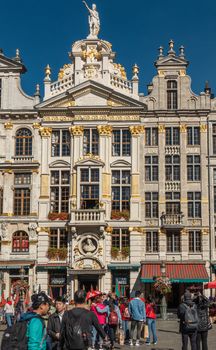 Brussels, Belgium - September 26, 2018: The white-gray facade with tall statues and patio in front of La Chaloupe d’Or, The Gulden Boot, bar and restaurant on Grand Place, Grote Markt. People up front.