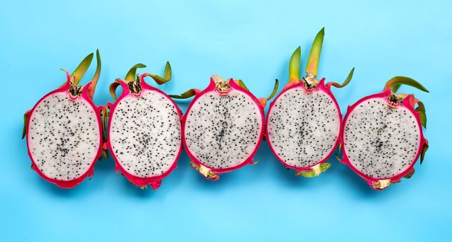 Ripe dragonfruit or pitahaya on blue background. Top view