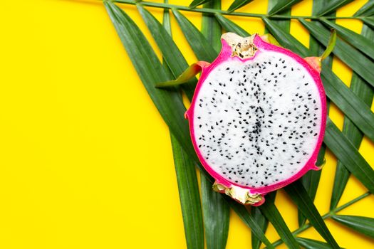 Ripe dragonfruit or pitahaya on tropical palm leaves. Top view