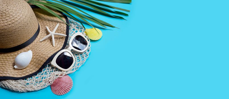 Summer hat with sunglasses on blue background. Enjoy holiday concept. Copy space