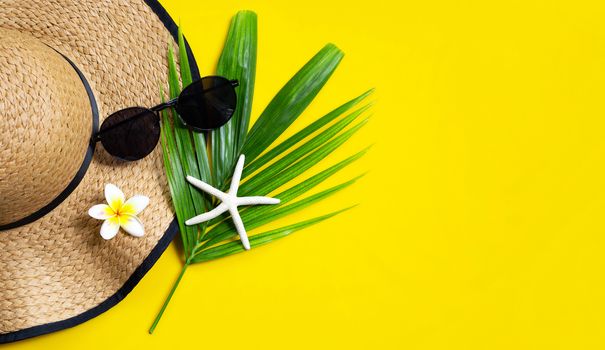 Summer hat with sunglasses on yellow background. Enjoy holiday concept. Copy space