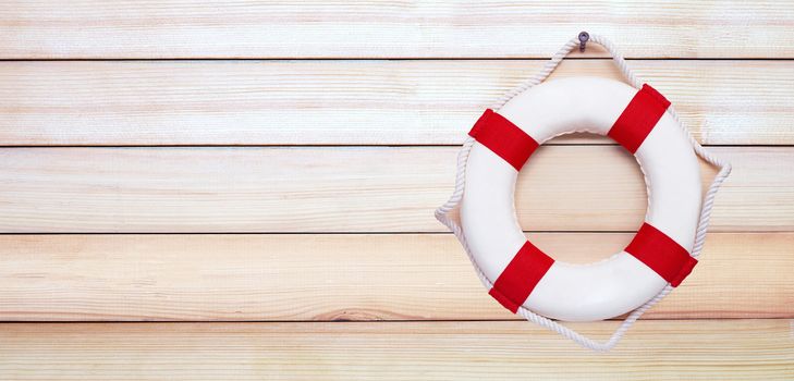 Lifebuoy on wooden background. Copy space