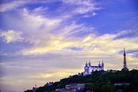 Lyon, France and the Basilica of Notre-Dame de Fourvière at sunset.