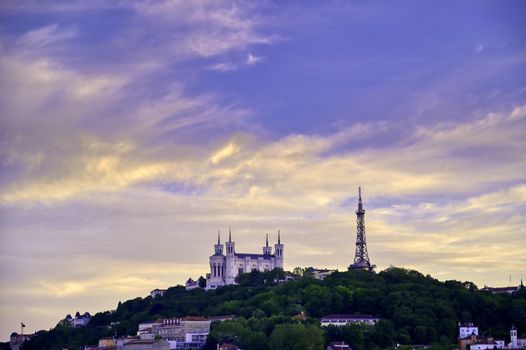 Lyon, France and the Basilica of Notre-Dame de Fourvière at sunset.