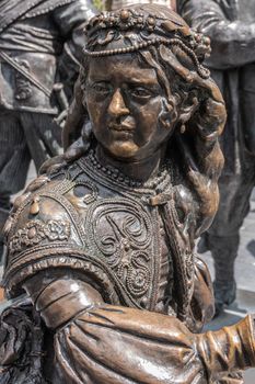 Amsterdam, the Netherlands - July 1, 2019: De Nachtwacht compostion of statues on Rembrandtplein. Closeup of bust of sole female figure.