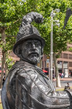 Amsterdam, the Netherlands - July 1, 2019: De Nachtwacht compostion of statues on Rembrandtplein. closeup of chest and head of soldier, warrior statue with feathered helmet.