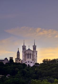 Lyon, France and the Basilica of Notre-Dame de Fourvière at sunset.