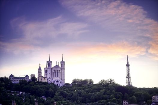 Lyon, France and the Basilica of Notre-Dame de Fourvière at sunset.