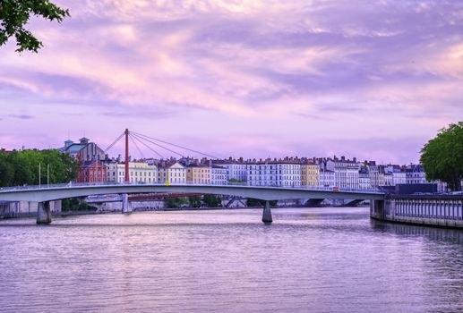 A view of Lyon, France along the Saône river at sunset.