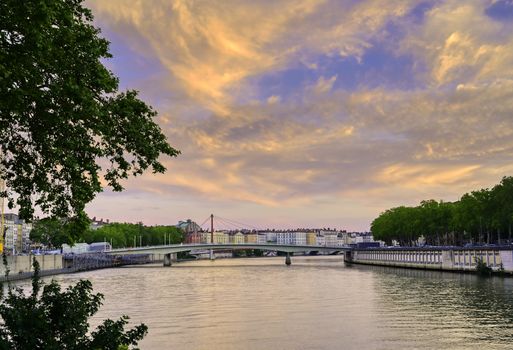 A view of Lyon, France along the Saône river at sunset.