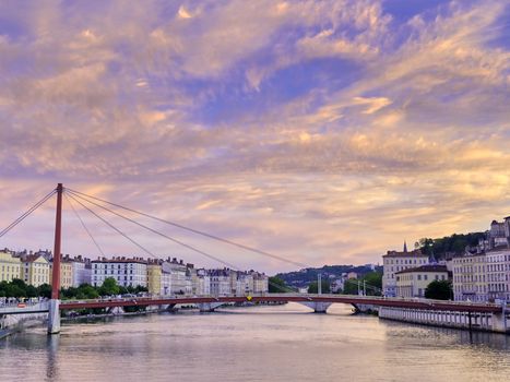 A view of Lyon, France along the Saône river at sunset.