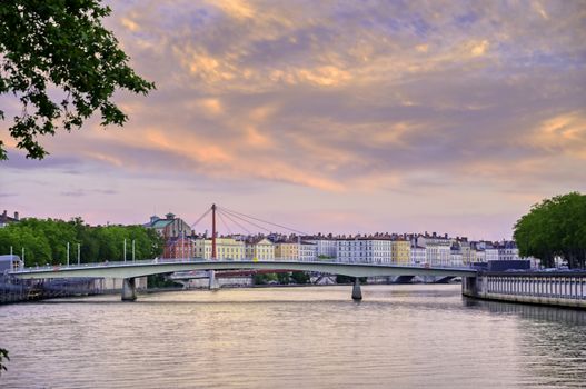 A view of Lyon, France along the Saône river at sunset.