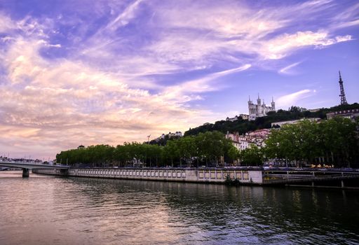 A view of Lyon, France along the Saône river at sunset.