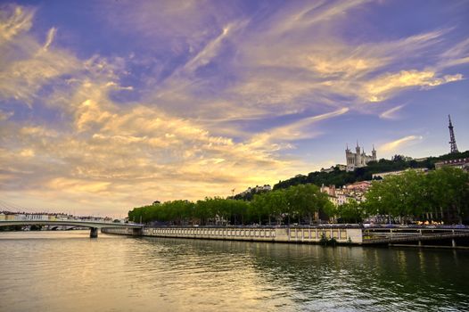 A view of Lyon, France along the Saône river at sunset.