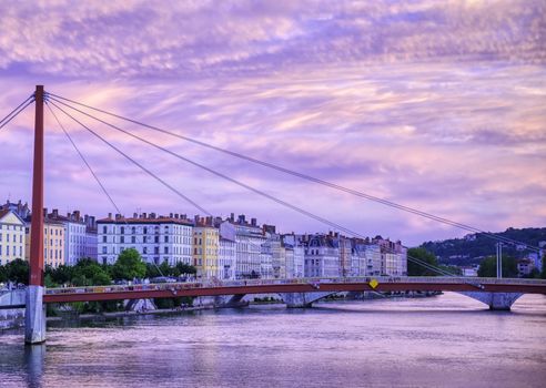 A view of Lyon, France along the Saône river at sunset.