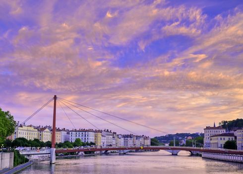 A view of Lyon, France along the Saône river at sunset.