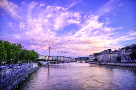 A view of Lyon, France along the Saône river at sunset.