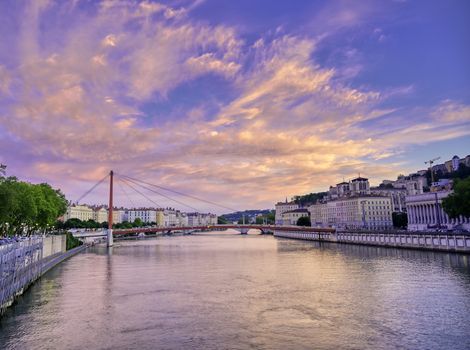 A view of Lyon, France along the Saône river at sunset.