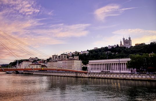 A view of Lyon, France along the Saône river at sunset.