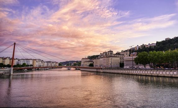 A view of Lyon, France along the Saône river at sunset.