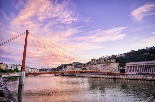 A view of Lyon, France along the Saône river at sunset.