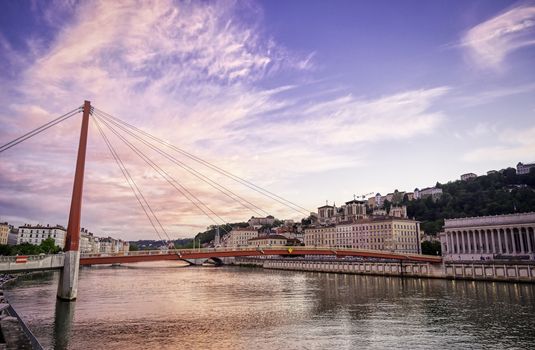 A view of Lyon, France along the Saône river at sunset.