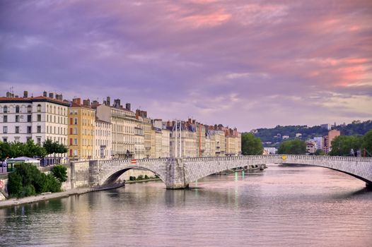 A view of Lyon, France along the Saône river at sunset.