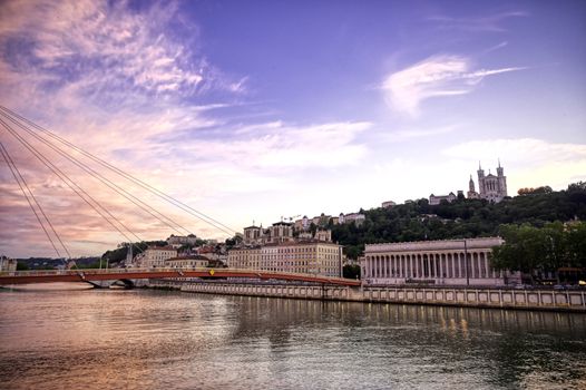 A view of Lyon, France along the Saône river at sunset.