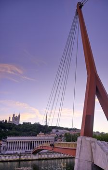 A view of Lyon, France along the Saône river at sunset.