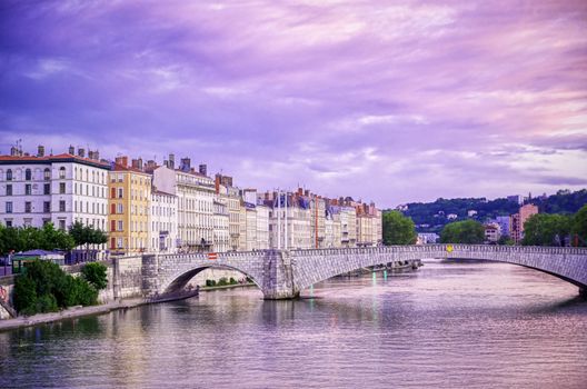 A view of Lyon, France along the Saône river at sunset.