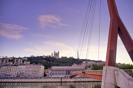 A view of Lyon, France along the Saône river at sunset.