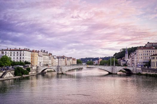 A view of Lyon, France along the Saône river at sunset.