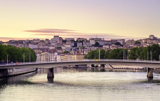 A view of Lyon, France along the Saône river at sunset.