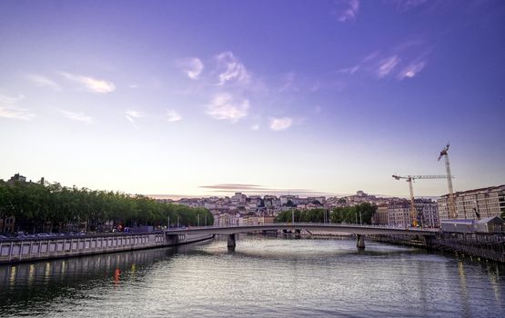 A view of Lyon, France along the Saône river at sunset.