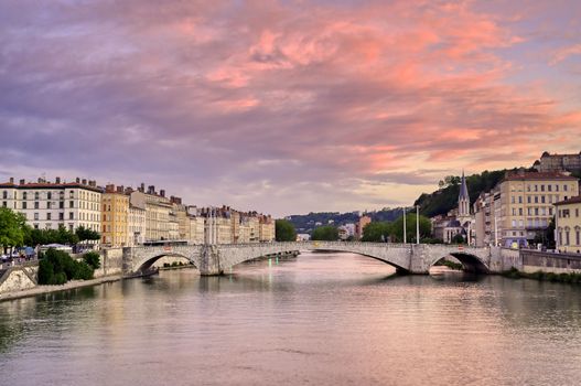 A view of Lyon, France along the Saône river at sunset.