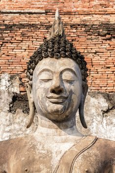 Ancient Buddha Statue at Wat Mahathat in Sukhothai historical park in Sukhothai, Thailand.
