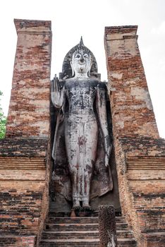 Ancient Buddha Statue at Wat Mahathat in Sukhothai historical park in Sukhothai, Thailand.