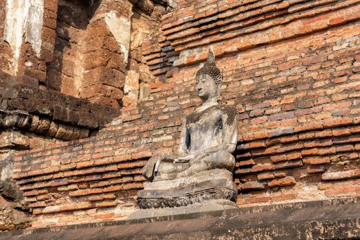 Ancient Buddha Statue at Wat Mahathat in Sukhothai historical park in Sukhothai, Thailand.