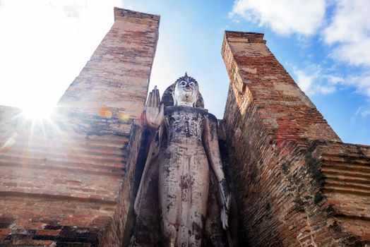 Ancient Buddha Statue at Wat Mahathat in Sukhothai historical park in Sukhothai, Thailand.