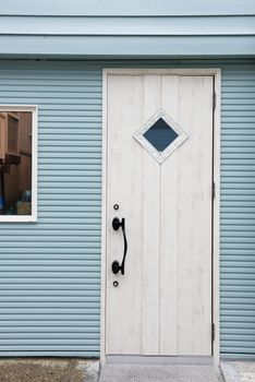 closed white wooden door on light blue wall