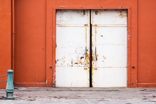 facade of old orange warehouse with white sliding doors