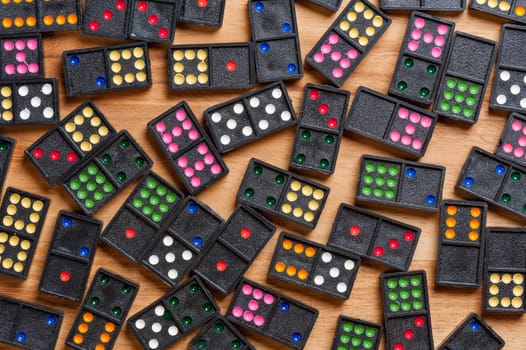 Dominoes on wooden table. Dominoes is a game played with rectangular "domino" tiles.